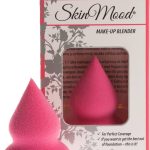 Tatinmuotoinen vaaleanpunainen meikkisieni ja tuotteen ikkunallinen pahvipakkaus tuoteteksteillä.